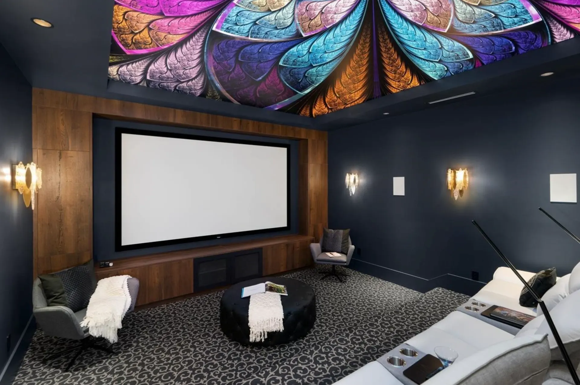 Cinema room with a projection screen, a theatre sofa, and a media console.