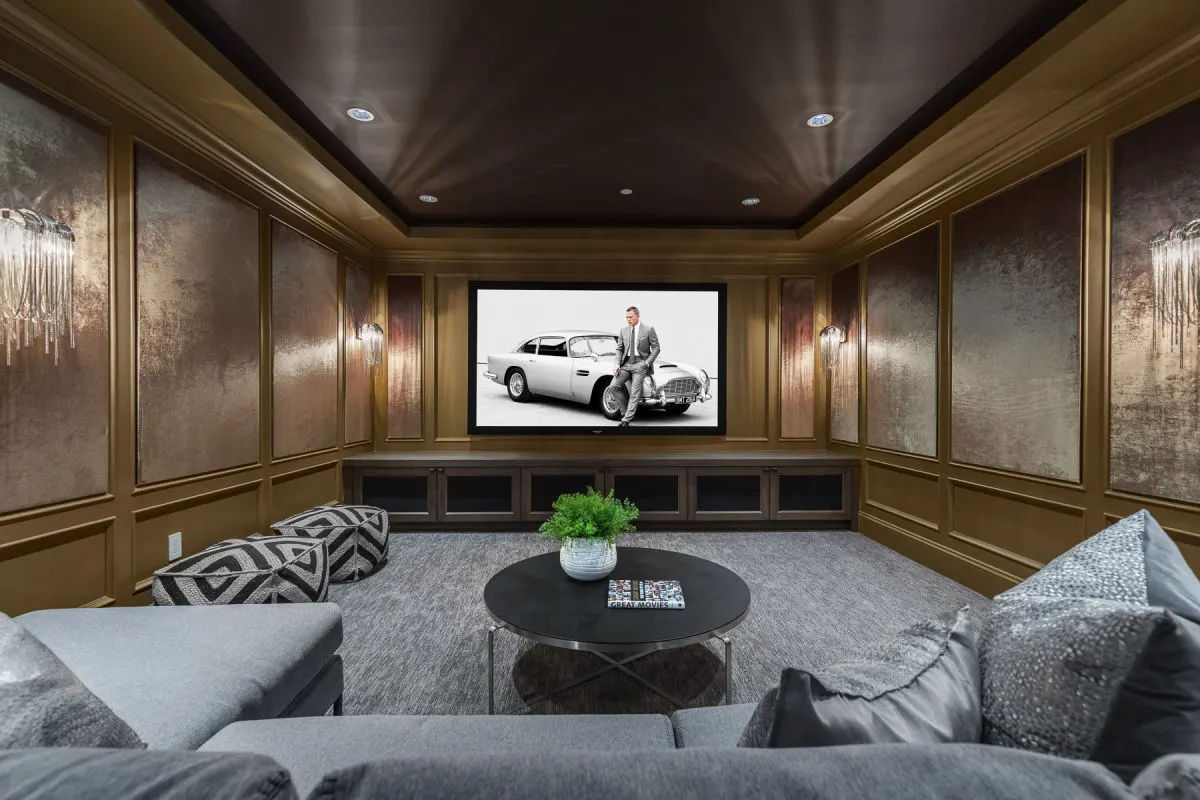 Home theatre with a projection screen, acoustic wall panels, and a media console.