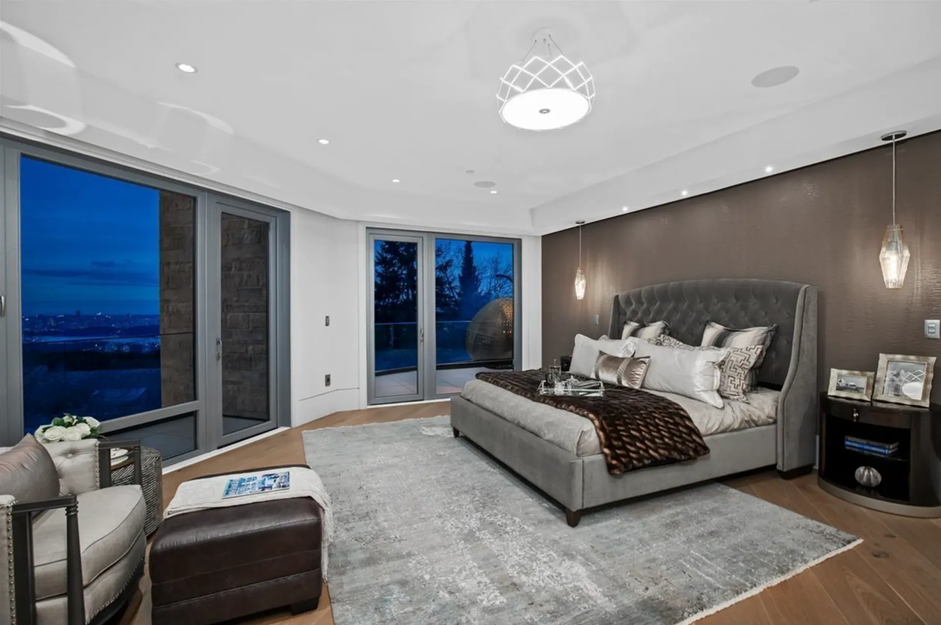 Bedroom with wall keypads, in-ceiling speakers, and recessed and pendant lighting.