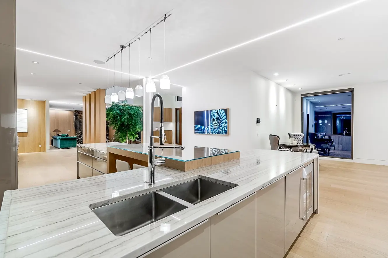 Kitchen with a wall keypad, linear lighting, and an in-ceiling speaker.